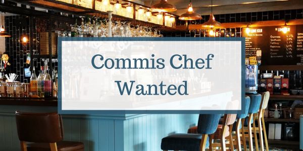 Interior of a modern gastrobar with a sign that reads 'Commis Chef Wanted' displayed prominently over the image